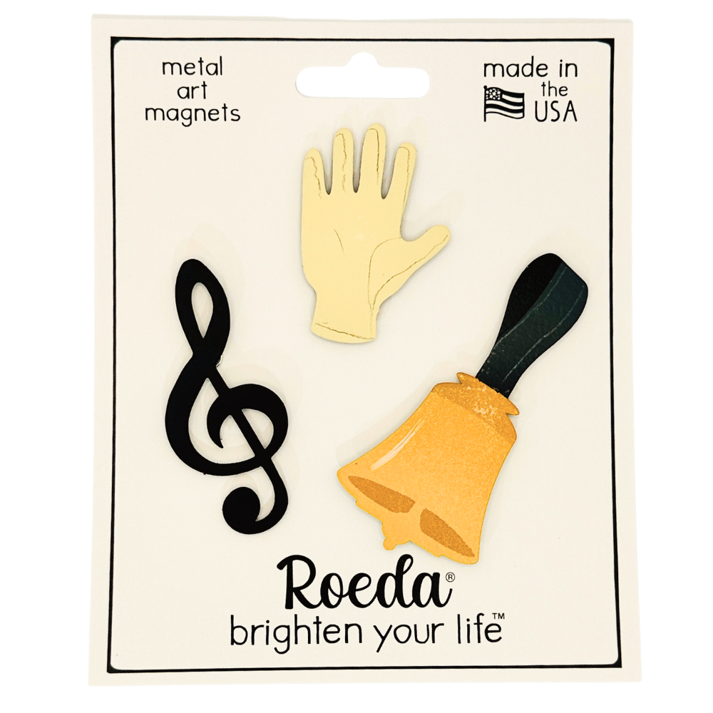 Cream glove, gold handbell, and black treble clef magnets on their Roeda packaging card