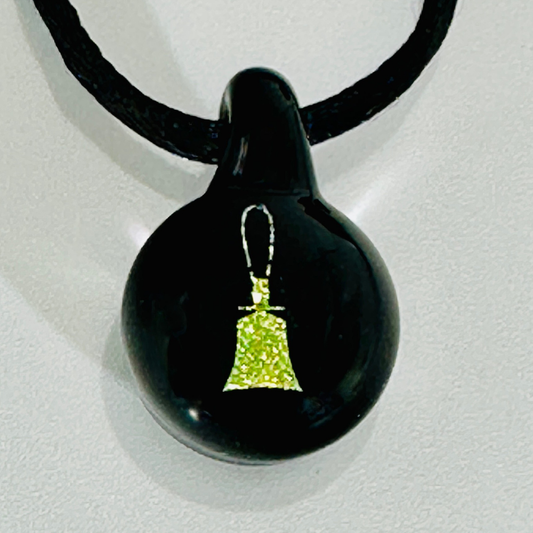 Black glass pendant with a sparkling gold-colored handbell silhouette and fine loop-shaped handle, hanging from a black satin cord.